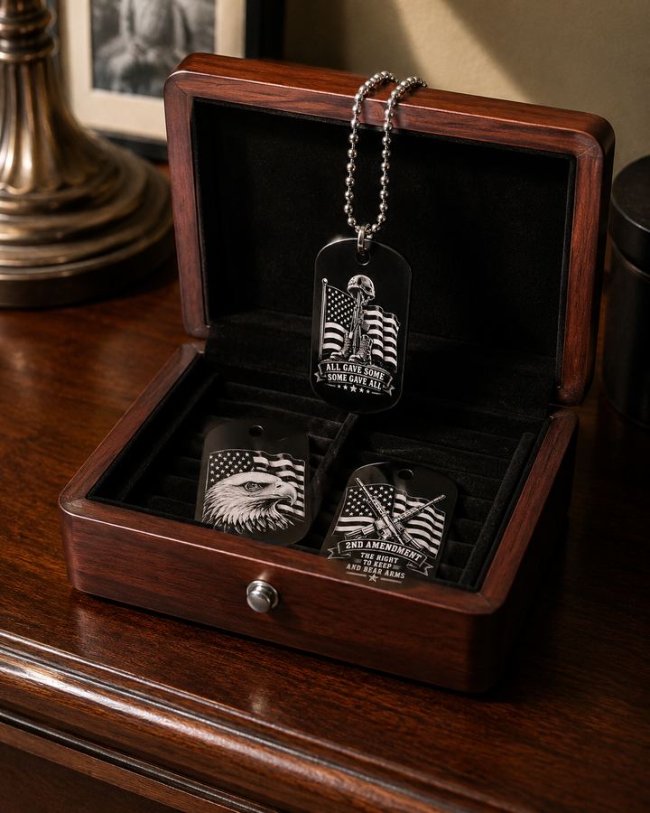 Engraved patriotic dog tags with American flag, eagle, and 2nd Amendment designs in a wooden case